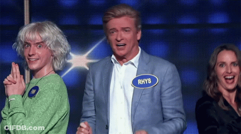 A Man With The Name Rhys On His Name Tag GIF