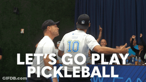 A Man With The Number 10 On His Back Is Hugging Another Man In Front Of A Sign That Says Let 'S Go Play Pickleball GIF
