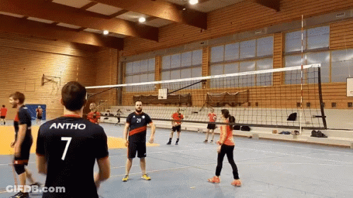 A Man With The Number 7 On His Back Stands In Front Of A Volleyball Net GIF