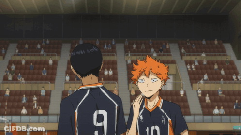 A Man With The Number 9 On His Back Stands Next To Another Man GIF