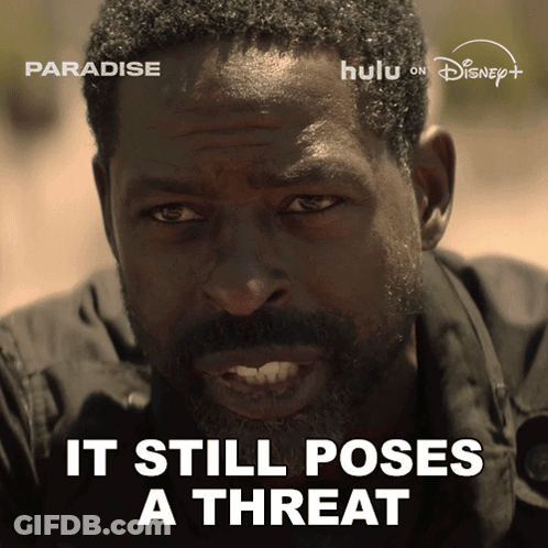 A Man With The Words " It Still Poses A Threat " On The Bottom GIF