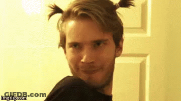 A Man With Two Pigtails In His Hair Is Making A Funny Face . GIF