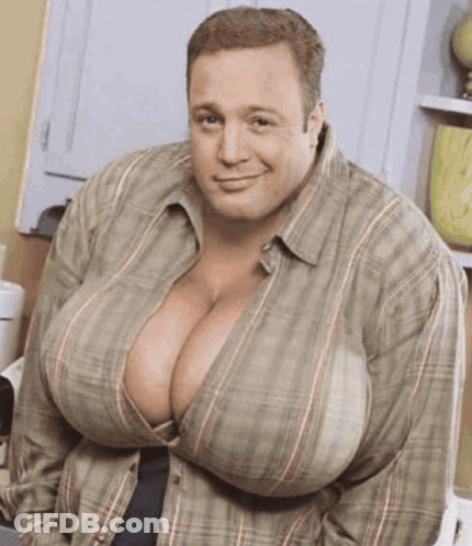 A Man With Very Large Breasts Is Wearing A Plaid Shirt And Smiling GIF