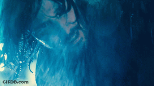 A Man With Wet Hair And A Beard Looks At The Camera GIF