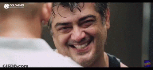 A Man With Wet Hair Is Smiling And Looking At Another Man 'S Face . GIF