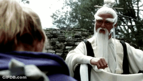 A Man With White Hair And A Beard Is Talking To Another Person GIF