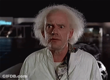 A Man With White Hair And A Beard Is Wearing A Lab Coat And Headphones . GIF