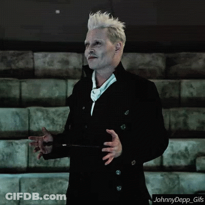A Man With White Hair And A Mustache Is Standing In Front Of A Row Of Bleachers . GIF