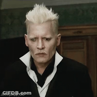 A Man With White Hair And A Mustache Is Wearing A Black Suit And White Shirt . GIF