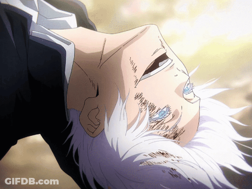 A Man With White Hair And Blue Eyes Is Laying Upside Down GIF