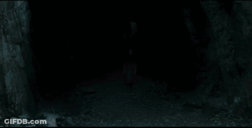 A Man With White Hair Is Holding A Knife In His Hand GIF