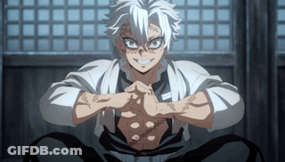 A Man With White Hair Is Sitting Down With His Hands Folded In Front Of Him . GIF