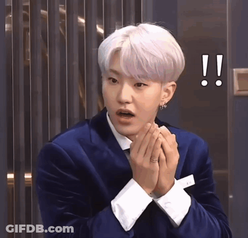 A Man With White Hair Is Wearing A Blue Suit And White Cuffs GIF
