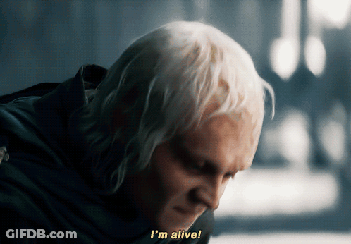A Man With White Hair Says " I 'M Alive " In Yellow Letters GIF