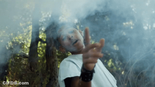 A Man With White Paint On His Face Is Pointing At The Camera GIF