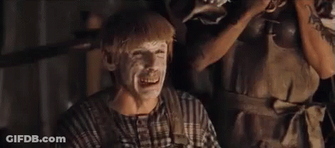 A Man With White Paint On His Face Is Sitting In Front Of A Woman . GIF
