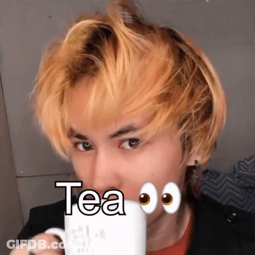 A Man With Yellow Hair Drinking A Cup Of Tea With Googly Eyes GIF