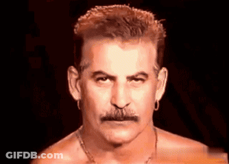 Man Without Shirt With Mustache And Earrings GIF