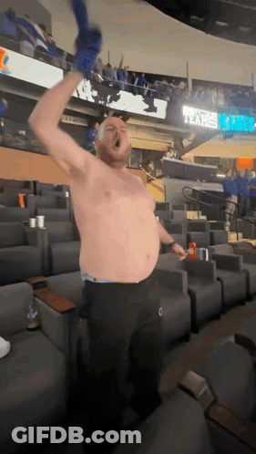 A Man Without A Shirt In A Stadium With A Sign That Says Tears On It GIF