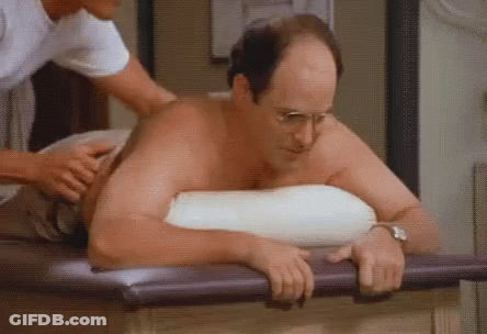 A Man Without A Shirt Is Getting A Massage From Another Man GIF