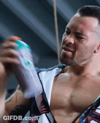 A Man Without A Shirt Is Holding A Bottle Of Lotion GIF