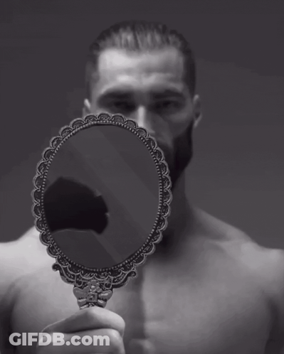 A Man Without A Shirt Is Holding A Small Mirror In Front Of His Face GIF