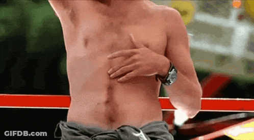 A Man Without A Shirt Is Holding His Chest With His Hand GIF