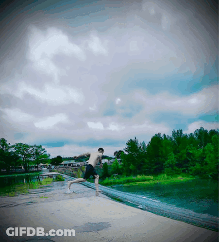 A Man Without A Shirt Is Jumping Into The Water GIF