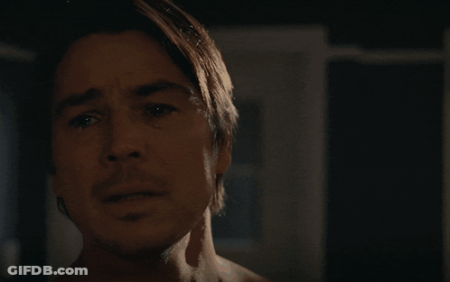 A Man Without A Shirt Is Looking At The Camera With A Serious Look On His Face GIF