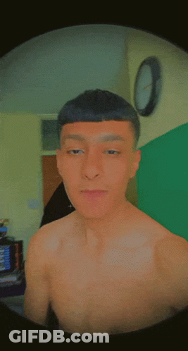 A Man Without A Shirt Is Making A Funny Face With His Eyes Closed GIF
