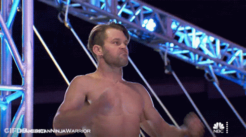 A Man Without A Shirt Is On A Nbc Show Called American Ninja Warrior GIF