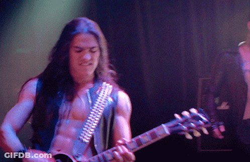 A Man Without A Shirt Is Playing A Guitar GIF