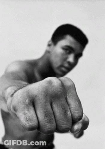 A Man Without A Shirt Is Pointing His Fist GIF