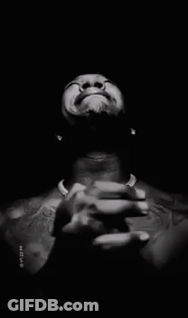 A Man Without A Shirt Is Praying With His Hands Folded In Front Of His Face . GIF