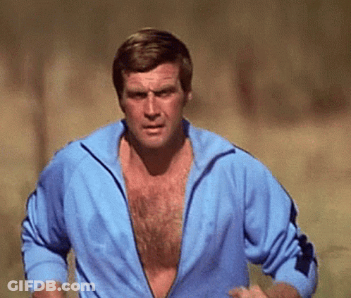 A Man Without A Shirt Is Running In A Field GIF
