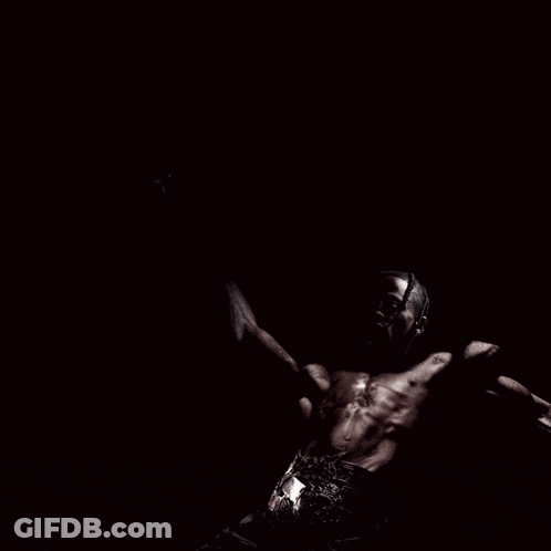A Man Without A Shirt Is Screaming With His Arms Outstretched GIF