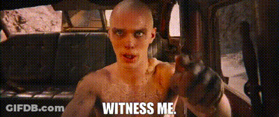 A Man Without A Shirt Is Sitting In A Car Holding A Gun And Saying `` Witness Me '' . GIF
