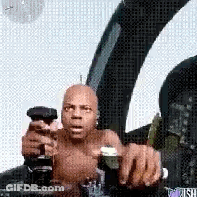A Man Without A Shirt Is Sitting In The Cockpit Of A Plane Holding A Remote Control . GIF