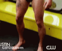 A Man Without A Shirt Is Sitting On A Yellow Couch With The Words Justin Behind Him GIF