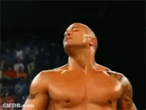 A Man Without A Shirt Is Standing In A Boxing Ring With His Eyes Closed . GIF