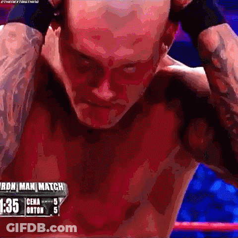 A Man Without A Shirt Is Standing In A Boxing Ring With His Hands Behind His Head . GIF