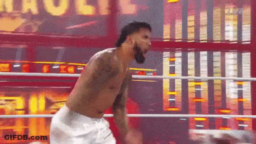 A Man Without A Shirt Is Standing In A Boxing Ring With The Word Hulk Behind Him GIF