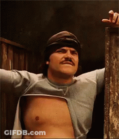 A Man Without A Shirt Is Standing In A Doorway GIF