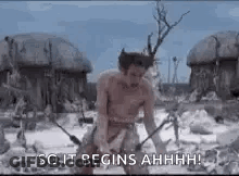A Man Without A Shirt Is Standing In A Field With A Sword In His Hand . GIF