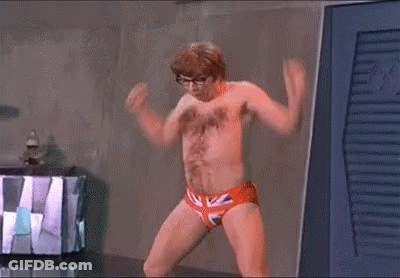 A Man Without A Shirt Is Standing In A Room Wearing British Flag Underwear . GIF