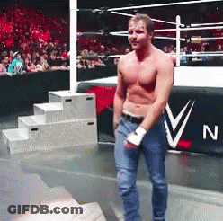 A Man Without A Shirt Is Standing In A Wrestling Ring In Front Of A Banner That Says N On It GIF