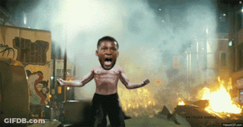 A Man Without A Shirt Is Standing In Front Of A Burning Building GIF