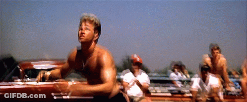 A Man Without A Shirt Is Standing In Front Of A Car GIF