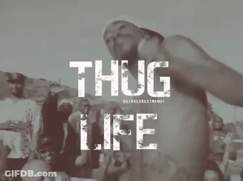 A Man Without A Shirt Is Standing In Front Of A Crowd With The Words Thug Life Above Him GIF
