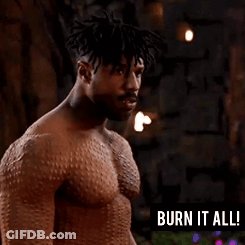 A Man Without A Shirt Is Standing In Front Of A Sign That Says Burn It All GIF